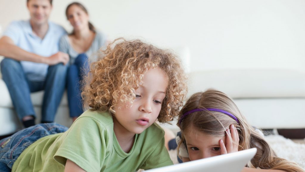 parents looking after children while they play on android tablet